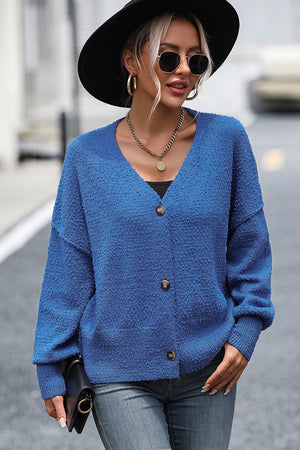 Blue textured bouclé button-down cardigan with V-neck and long sleeves.