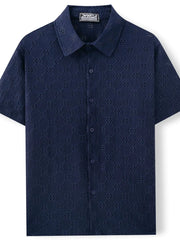 Navy geometric eyelet short sleeve resort shirt with button front and collar.