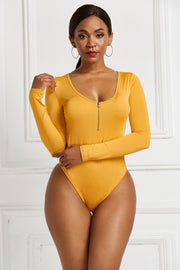 Long sleeve mustard yellow bodysuit with plunge neckline and front zipper detail.