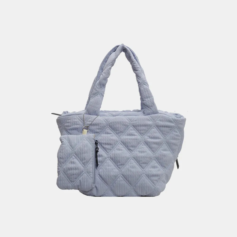 Quilted shopper tote bag in light blue with diamond pattern and attached coin purse.