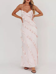 Blush pink ruffled spaghetti strap maxi dress with diagonal ruffle trim.