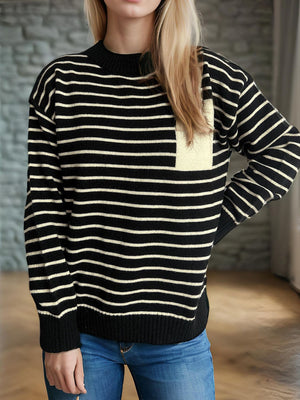 Black and cream striped knit sweater with asymmetrical pocket detail.