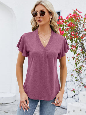 V-neck pleated flutter sleeve top in a muted coral hue, featuring a casual, relaxed fit.