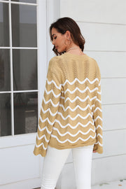 Khaki openwork knit sweater with white wavy stripes and long sleeves.