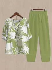 Floral print half sleeve top and lime green pants set with round neckline and cuffed sleeves.