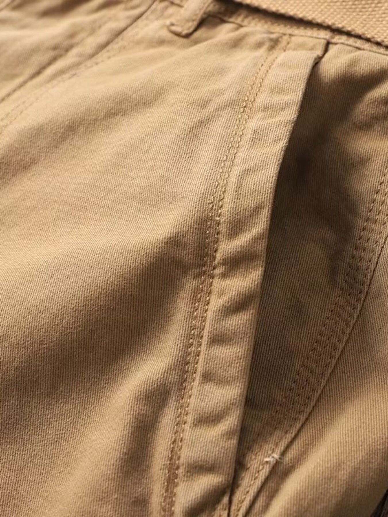 Tan cargo sweatpants with visible stitching detail and pocket opening.