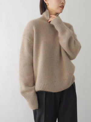 Relaxed fit khaki cashmere turtleneck sweater with ribbed cuffs and hem.