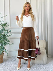 Tiered velvet midi skirt in brown with white scalloped trim detail.
