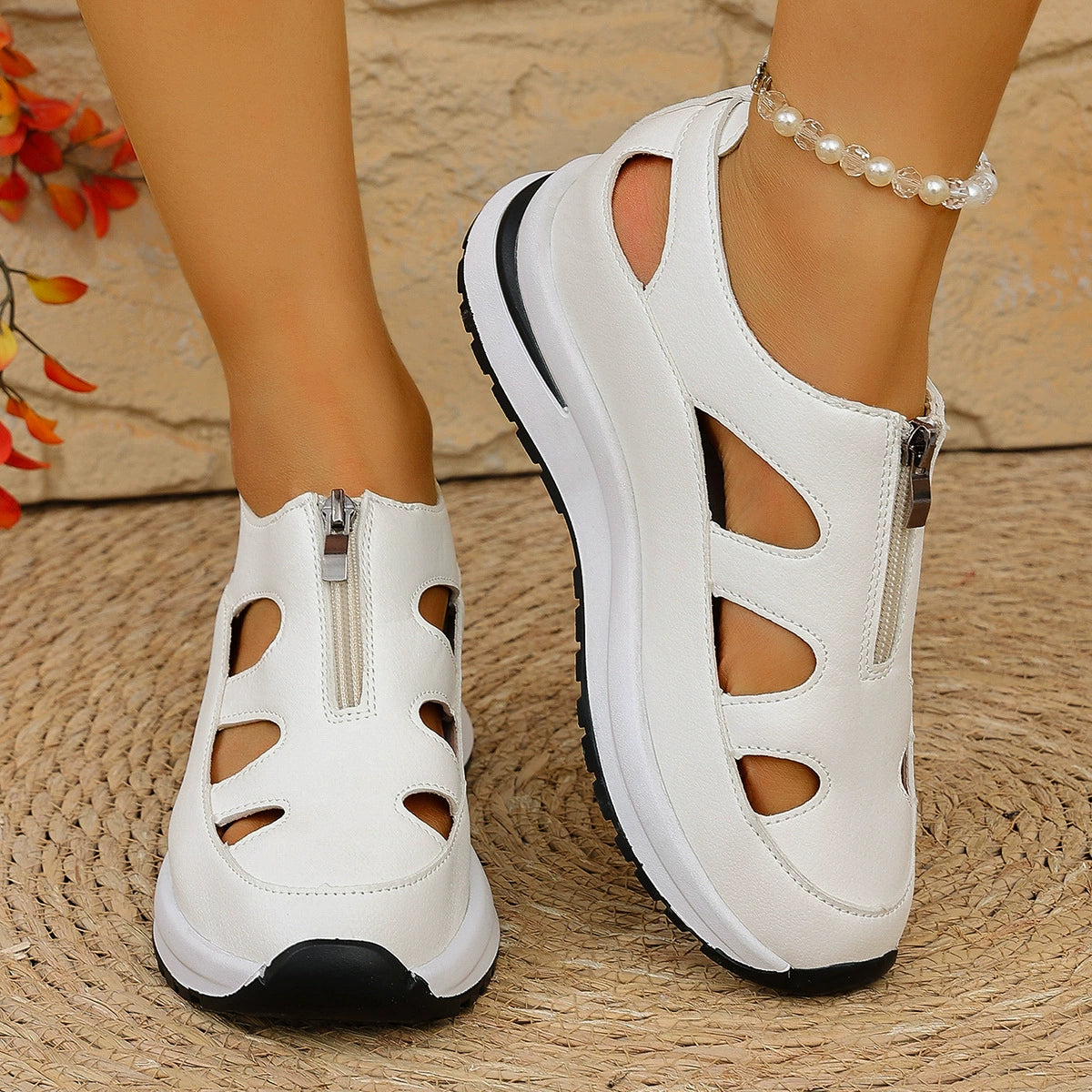 White cutout wedge sneakers with zipper detail and chunky sole.