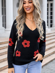 Black v-neck knit sweater with red daisy print, long sleeves.