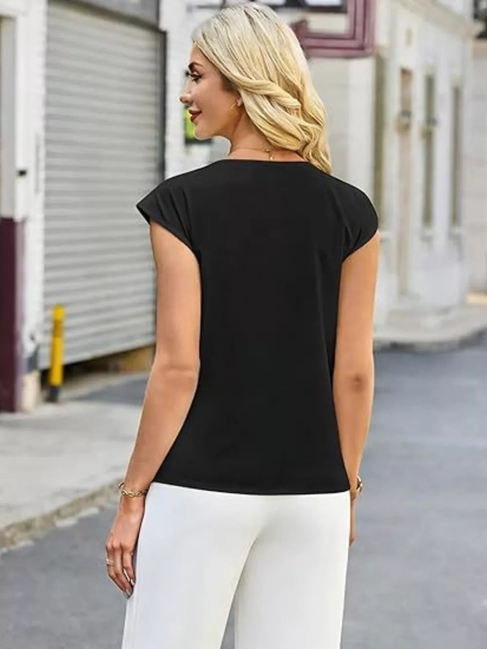 Black v-neck t-shirt with cap sleeves and button detail