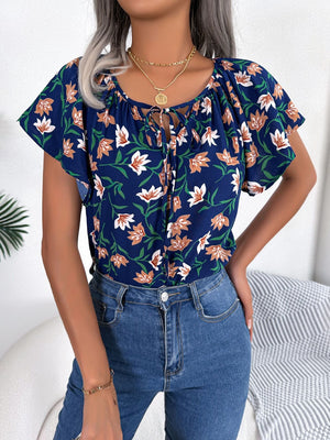 Dark blue floral blouse with ruffle sleeves and tie-neck detail