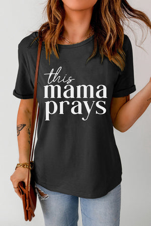 Black graphic tee with white script text that says "this mama prays".