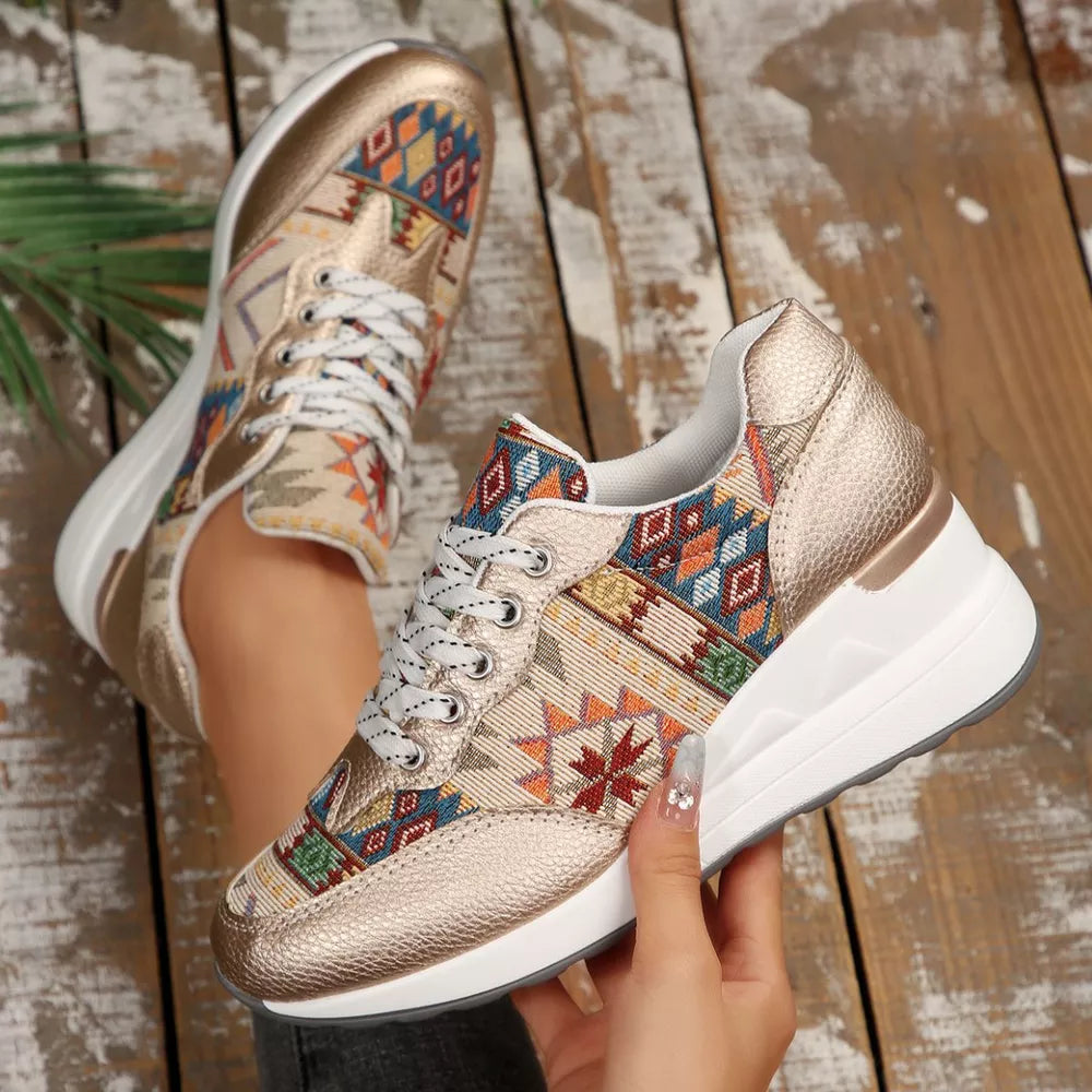Gold geometric patterned wedge sneakers with a chunky sole.
