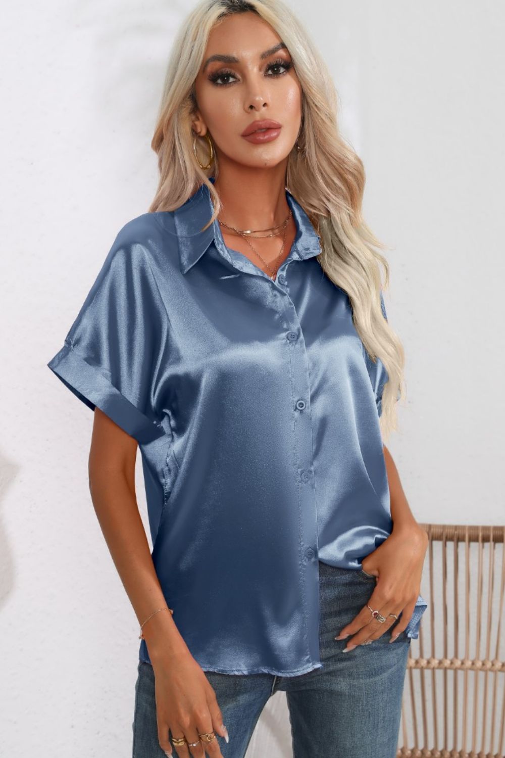 Light blue satin button-down blouse with cuffed short sleeves and a relaxed fit.