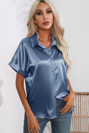Light blue satin button-down blouse with cuffed short sleeves and a relaxed fit.
