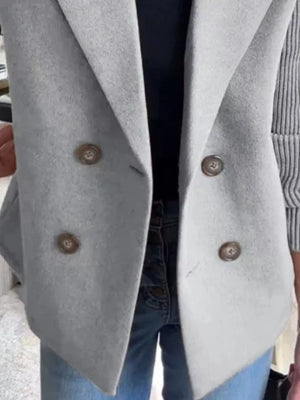 Double-breasted gray wool blend blazer with brown buttons, worn with jeans.