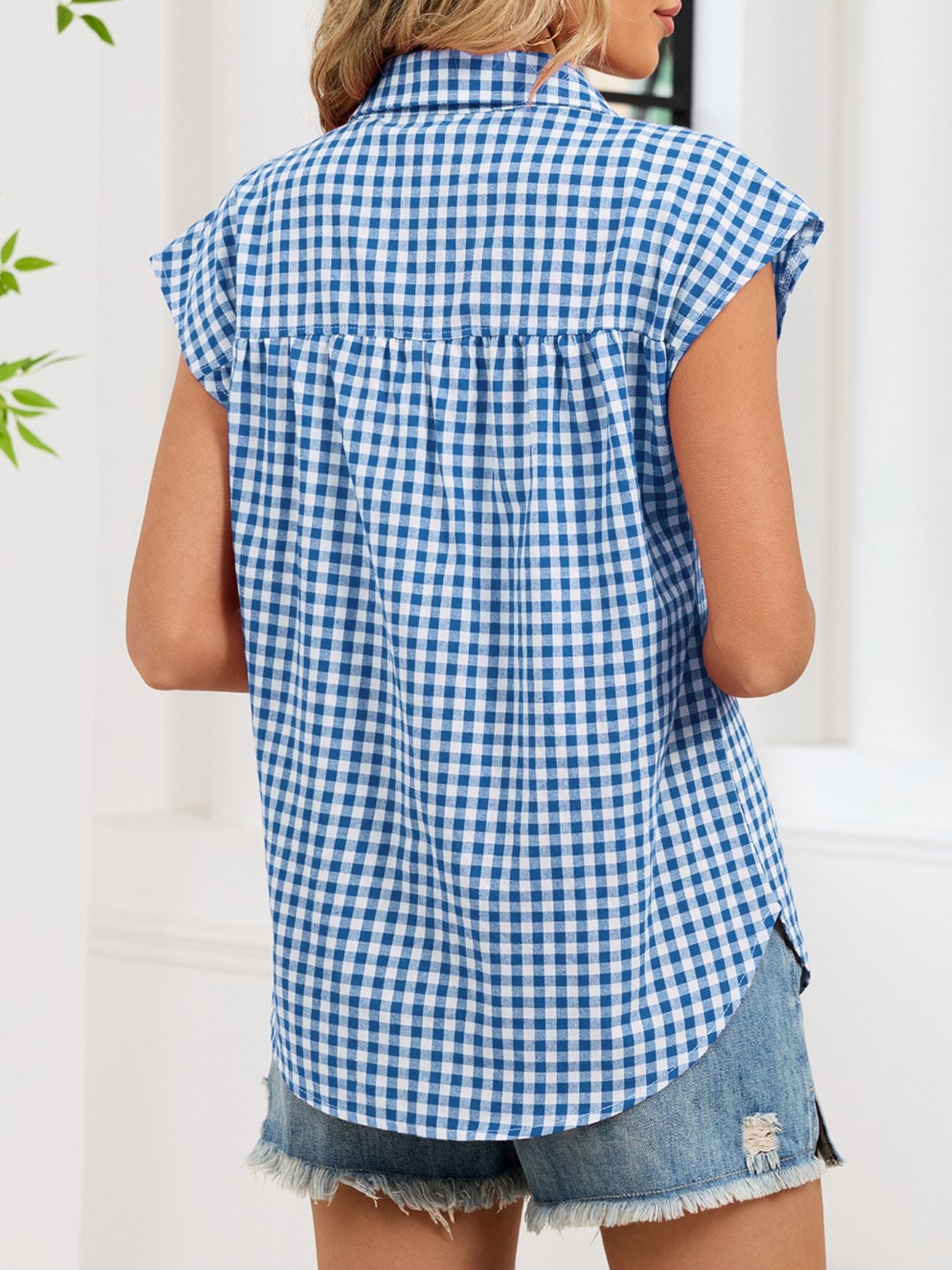 Blue gingham cotton shirt with cap sleeves and button-down front, shown from the back.