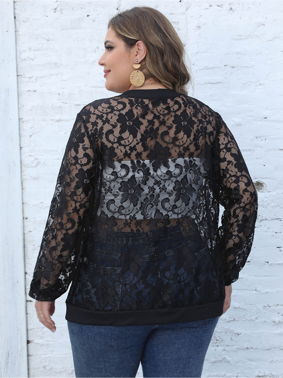 Black lace bomber jacket with ribbed trim and sheer floral pattern.