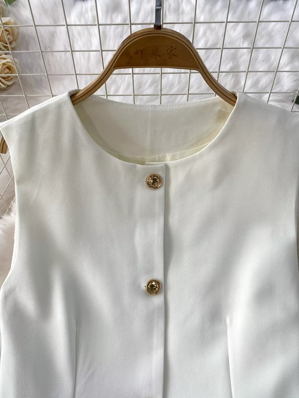 White belted two-piece set with gold button detail and pockets