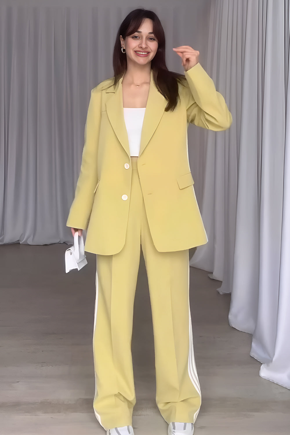 Pastel yellow pant suit with track stripes on the pants and a matching blazer.