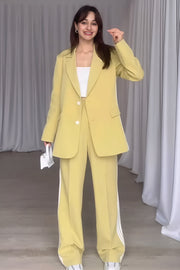 Pastel yellow pant suit with track stripes on the pants and a matching blazer.