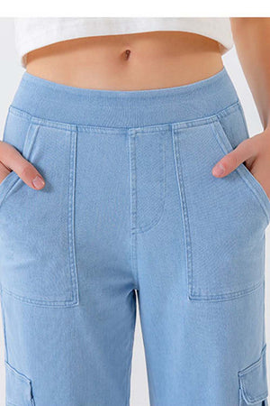 Light wash denim cargo pants with front pockets and utility details.