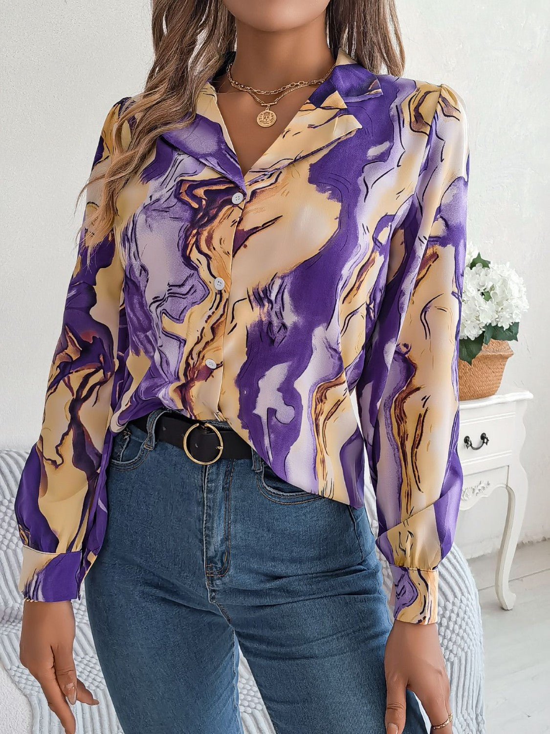 Women's abstract swirl print silk blouse in purple and yellow, with button front and long sleeves.