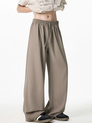 Relaxed taupe palazzo trousers with drawstring waist and wide leg.