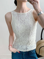White lace tank top with floral pattern and sheer detail.