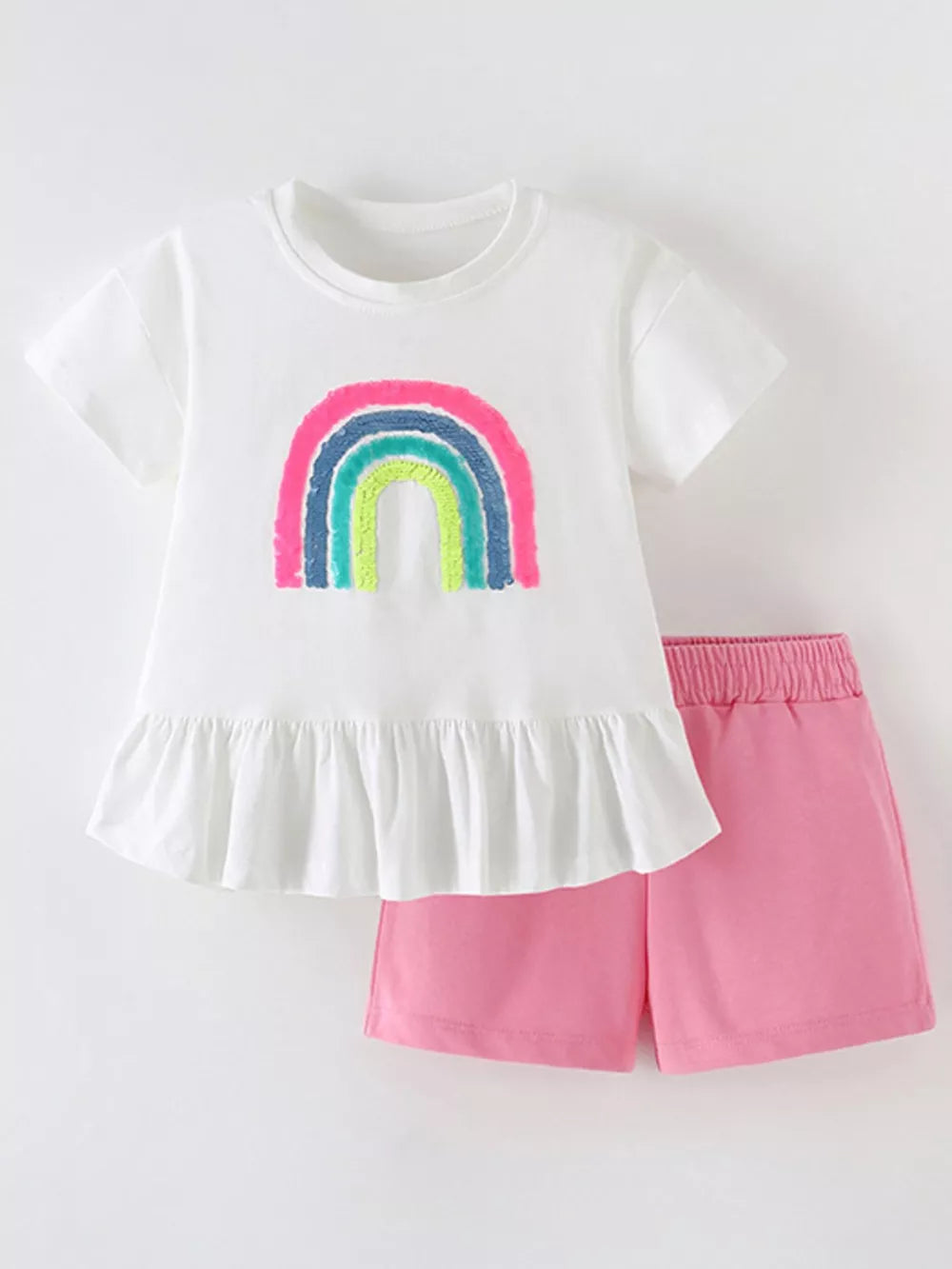 Girls' white rainbow sequin top with ruffled hem and pink shorts set