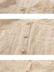 Apricot lace button-down crop top with pearl buttons and intricate embroidery detail.