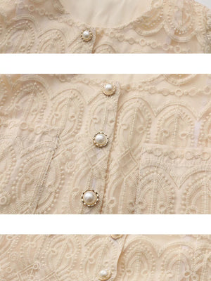 Apricot lace button-down crop top with pearl buttons and intricate embroidery detail.
