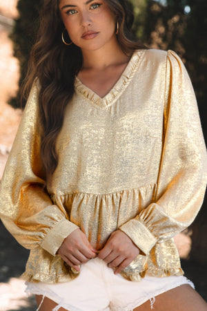 Metallic gold blouse with gathered sleeves, V-neck, and tiered hem.