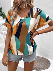 Geometric print V-neck blouse with short sleeves in multicolor.