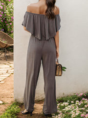 Dark Gray off-the-shoulder flounce jumpsuit with wide legs.