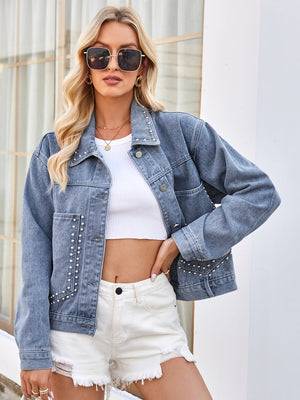 Pearl-embellished medium wash denim trucker jacket with button front and pockets.
