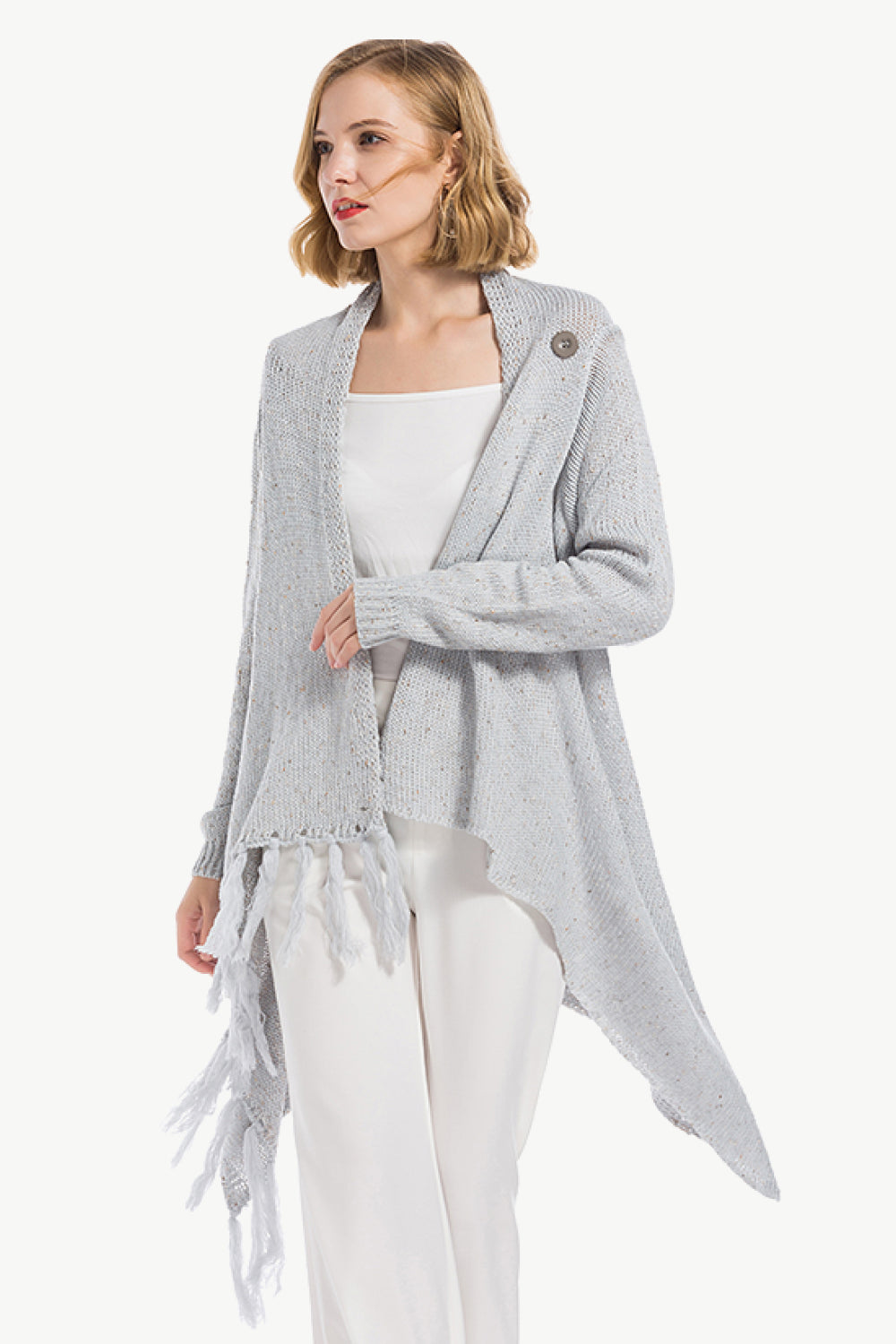 Gray asymmetric fringe knit cardigan with button detail and waterfall hem.