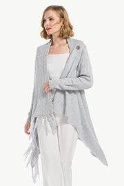 Gray asymmetric fringe knit cardigan with button detail and waterfall hem.