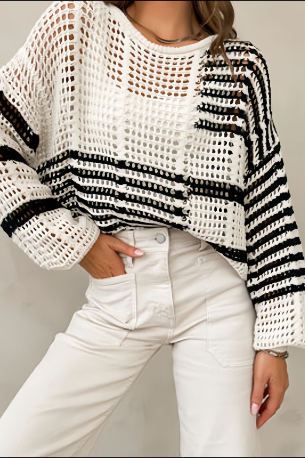 White crochet knit pullover sweater with black stripes and balloon sleeves.