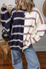 Colorblock stripe knit pullover with crewneck and long sleeves.