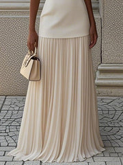 Elegant cream sleeveless top with pleated maxi skirt set, boat neck, flowing skirt.