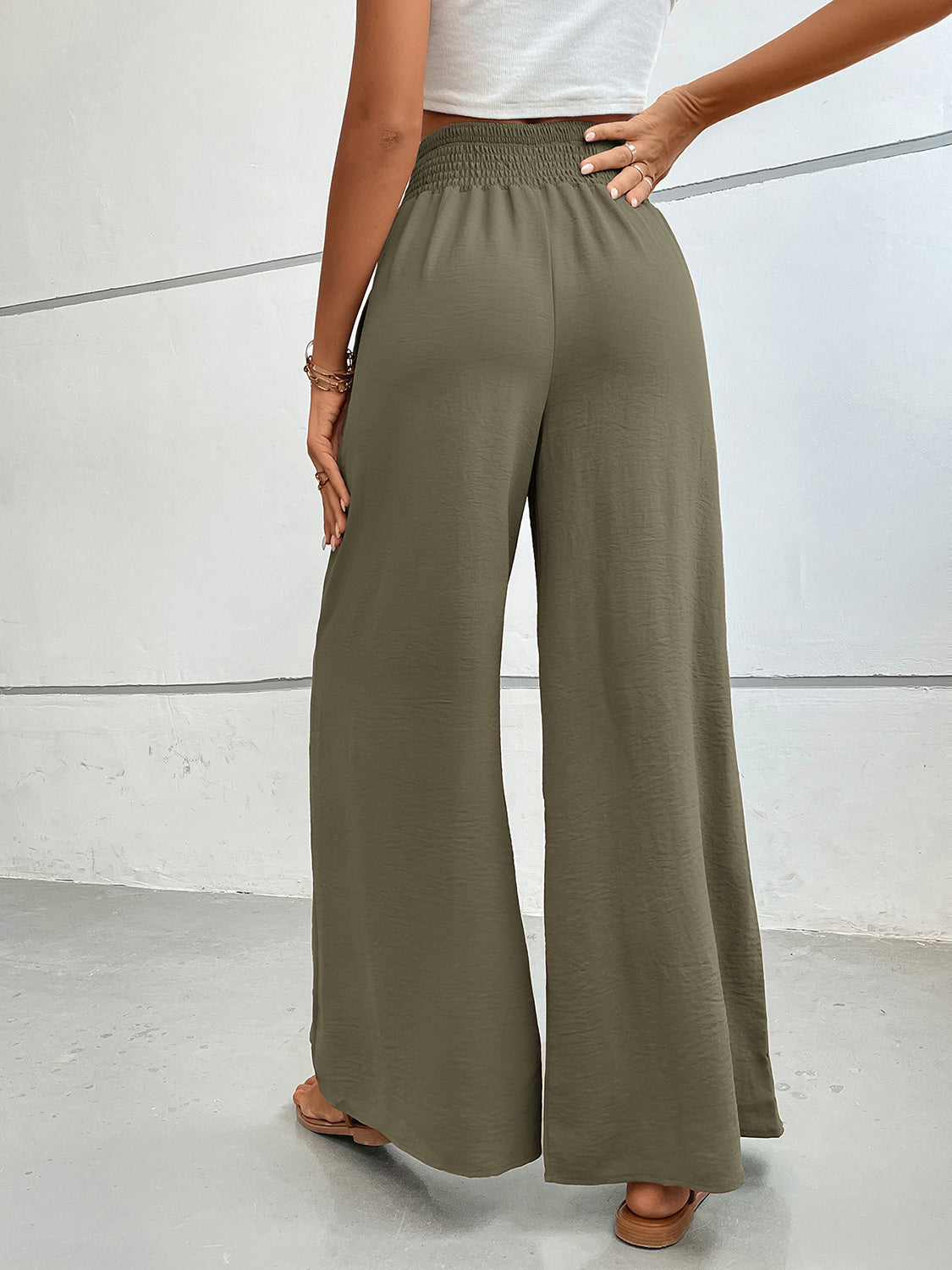 Textured palazzo lounge trousers in moss green with a smocked waistband.