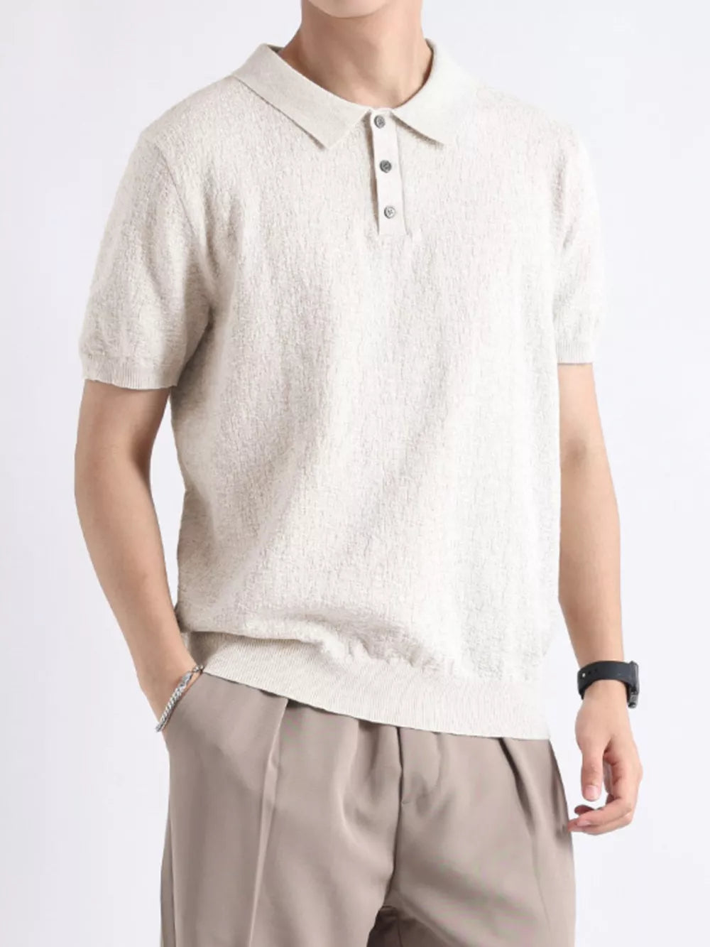 Beige cotton blend short-sleeve polo with button detail and classic collar.