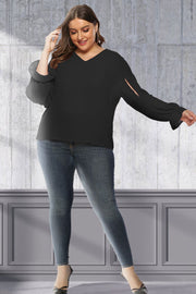 Black V-neck blouse with sleeve cutouts and ruffled cuffs.
