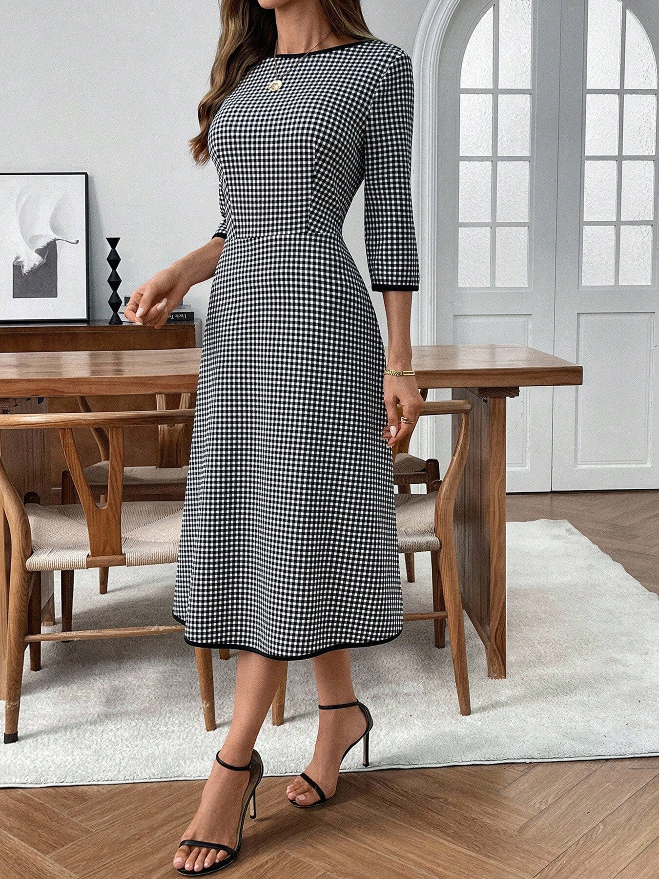 Black and white gingham midi dress with 3/4 sleeves and a-line cut.