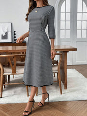 Black and white gingham midi dress with 3/4 sleeves and a-line cut.