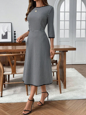 Black and white gingham midi dress with 3/4 sleeves and a-line cut.