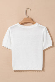White eyelet knit puff sleeve top with scalloped hem and cuffs