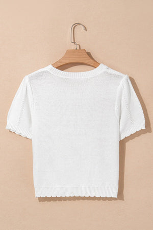 White eyelet knit puff sleeve top with scalloped hem and cuffs